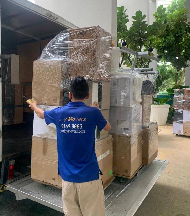 loading pile of storage boxes into moving truck